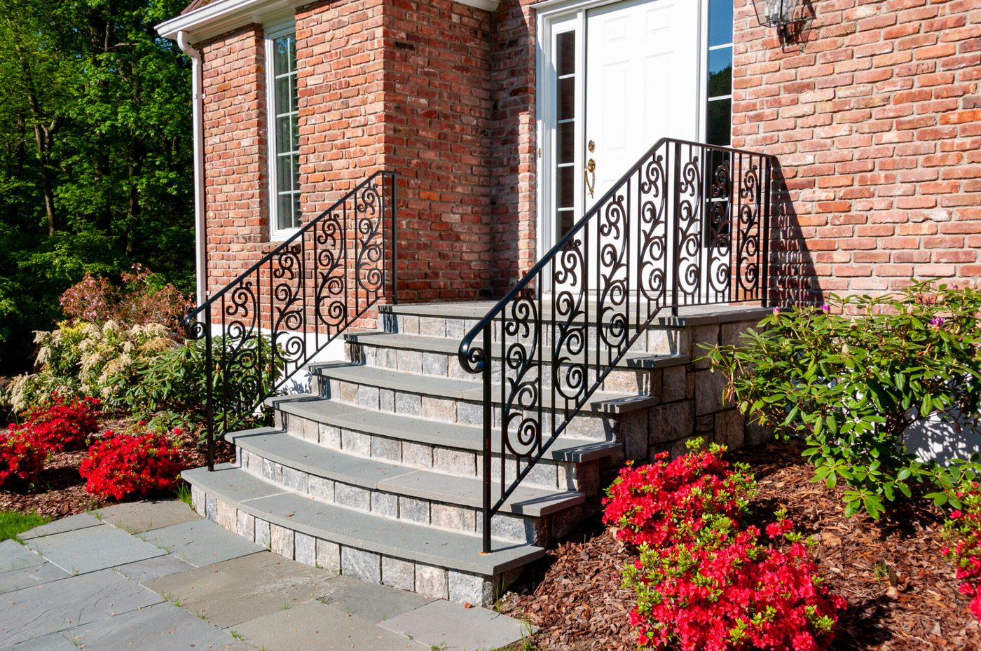 Ornamental iron stair railing at a home entrance